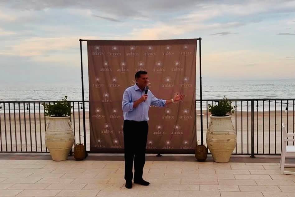 Ryan Elijah speaking to supporters at a beachfront event