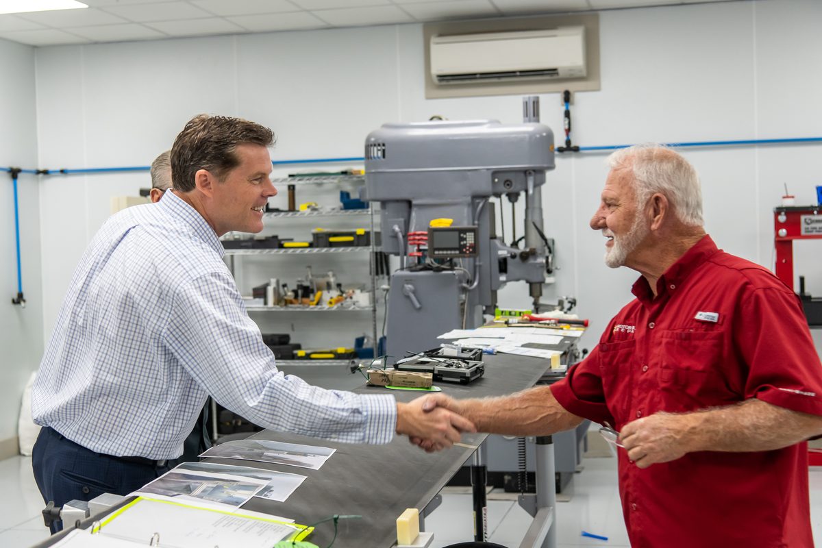 Ryan Elijah shaking hands with a Central Florida small business owner